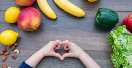 Kid,Making,Heart,Shape,With,Her,Hands,And,Healthy,Food